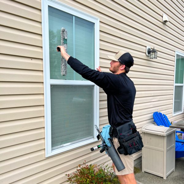 Julian cleaning an exterior window